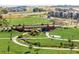 Scenic park view with walking paths, lush green spaces, and a bridge crossing a creek at 320 Marshall Mews, Superior, CO 80027