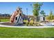 Unique wooden playground structure with slide and climbing features, set in a grassy park at 320 Marshall Mews, Superior, CO 80027