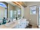 Bright bathroom featuring double sinks, a window, and shower at 815 Concho Ct, Castle Rock, CO 80104