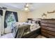 Comfortable bedroom with large window and wooden dresser set at 815 Concho Ct, Castle Rock, CO 80104