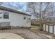 Side yard featuring shed, landscaped area, and home generator at 815 Concho Ct, Castle Rock, CO 80104