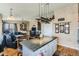 Gourmet kitchen flows to living room featuring center island and pendant lighting at 815 Concho Ct, Castle Rock, CO 80104