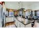 Gourmet kitchen flows to living room with stainless steel and white cabinets at 815 Concho Ct, Castle Rock, CO 80104