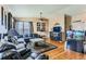 Spacious living room featuring hardwood floors, plush seating, an aquarium, and large windows at 815 Concho Ct, Castle Rock, CO 80104