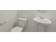 Small bathroom with white pedestal sink and toilet, plus chrome towel bar at 842 N Deer Park St, Watkins, CO 80137