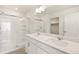 Modern bathroom features double sinks, walk in shower with glass doors, and neutral paint at 842 N Deer Park St, Watkins, CO 80137