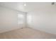 Well lit bedroom features neutral carpet, double hung windows, and a door at 842 N Deer Park St, Watkins, CO 80137