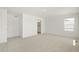 A spacious bedroom features an ensuite bath, plush carpet, and neutral paint at 842 N Deer Park St, Watkins, CO 80137