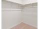 View of walk in closet with installed metal shelving and neutral carpeting at 842 N Deer Park St, Watkins, CO 80137