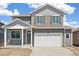 Charming two-story home featuring a two-car garage and a covered front porch at 842 N Deer Park St, Watkins, CO 80137