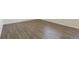 Close-up of durable wood flooring with white baseboards and light walls at 842 N Deer Park St, Watkins, CO 80137