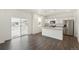 Well-lit kitchen with stainless steel appliances, granite countertops, and sliding glass doors to the backyard at 842 N Deer Park St, Watkins, CO 80137