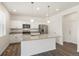 Modern kitchen with stainless steel appliances, granite countertops, and pendant lighting at 842 N Deer Park St, Watkins, CO 80137