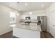 A modern kitchen with a granite island, stainless steel appliances, and recessed lighting at 842 N Deer Park St, Watkins, CO 80137
