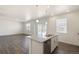 Open-concept kitchen and living area with a granite island and stainless steel dishwasher at 842 N Deer Park St, Watkins, CO 80137