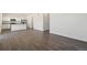 Open-concept living area showcases wood floors, white walls, and a modern kitchen setup at 842 N Deer Park St, Watkins, CO 80137