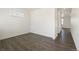 Bright, empty room offering versatile use with durable wood flooring at 842 N Deer Park St, Watkins, CO 80137