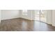 Large room featuring durable wood flooring and a sliding glass door at 842 N Deer Park St, Watkins, CO 80137