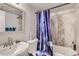 Cozy bathroom with a tub and a blue-themed shower curtain at 940 S Peoria St, Aurora, CO 80012