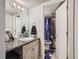 Bathroom with updated vanity, granite countertop, and shower with curtain at 940 S Peoria St, Aurora, CO 80012