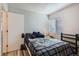 Bright bedroom featuring a cozy bed and a window with blinds at 940 S Peoria St, Aurora, CO 80012