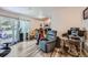 Comfortable living room with wood floors, a sliding glass door to the outside, and a partial view into the kitchen at 940 S Peoria St, Aurora, CO 80012