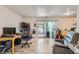 Open living area features natural light from sliding glass doors and comfortable seating arrangement at 940 S Peoria St, Aurora, CO 80012