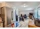 Combined living and dining area with stainless steel appliances, mini fridge, and open floor at 940 S Peoria St, Aurora, CO 80012
