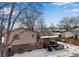 Elevated backyard with patio furniture and grill, winter view at 8653 W 67Th Ave, Arvada, CO 80004