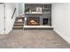 Basement Gathering room with a brick fireplace and carpeted floors at 8653 W 67Th Ave, Arvada, CO 80004