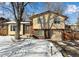 Ranch style home with brick accents and a two-car garage, nestled on a tree-lined street at 8653 W 67Th Ave, Arvada, CO 80004