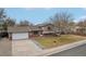 Ranch-style home with a two-car garage and well-maintained lawn at 327 S 29Th Ave, Brighton, CO 80601