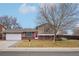 House exterior featuring a two-car garage and well-manicured lawn at 327 S 29Th Ave, Brighton, CO 80601