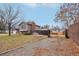 Exterior view of the home showcasing a gravel driveway and side yard at 327 S 29Th Ave, Brighton, CO 80601