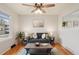 Living room featuring hardwood floors, a comfy couch, and a large window at 327 S 29Th Ave, Brighton, CO 80601