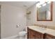 Bathroom featuring a wood vanity with a light countertop and decorative backsplash at 4441 Elm Ct, Denver, CO 80211