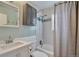Bathroom featuring a shower-tub combination with white subway tiles, modern sink, and cabinet at 4441 Elm Ct, Denver, CO 80211
