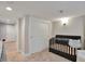 Well-lit Bedroom featuring a dark crib, carpet and bright walls at 4441 Elm Ct, Denver, CO 80211