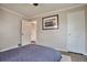 Bedroom with wood floors, base trim, ceiling fan, and artwork at 4441 Elm Ct, Denver, CO 80211