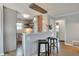 Modern kitchen with breakfast bar open to dining area featuring stylish lighting at 4441 Elm Ct, Denver, CO 80211