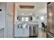 Open kitchen design with stainless appliances and a pass-through to dining area at 4441 Elm Ct, Denver, CO 80211