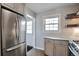 Updated kitchen with stainless refrigerator, granite countertops, and custom cabinets at 4441 Elm Ct, Denver, CO 80211