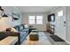 Cozy living room with stylish sectional sofa and large window for natural light at 4441 Elm Ct, Denver, CO 80211