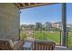 Balcony seating with views of community lawn and nearby houses on a beautiful sunny day at 6047 N Nepal Ct, Aurora, CO 80019