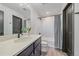 Stylish bathroom featuring a modern vanity, sleek fixtures, and shower with decorative tile at 6047 N Nepal Ct, Aurora, CO 80019