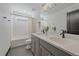 An elegant bathroom features a double sink vanity, modern fixtures, and a shower-tub combination at 6047 N Nepal Ct, Aurora, CO 80019