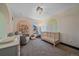 A delightful Bedroom is adorned with soft, neutral tones, playful rainbow accents, and comfortable furnishings at 6047 N Nepal Ct, Aurora, CO 80019