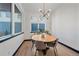 Cozy dining area featuring hardwood floors, a round table, and modern lighting fixture at 6047 N Nepal Ct, Aurora, CO 80019