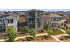 Modern home with stone accents, multiple balconies, and well-maintained landscaping provides exceptional curb appeal at 6047 N Nepal Ct, Aurora, CO 80019