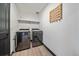 A modern laundry room boasts sleek, stainless steel washer and dryer units, maximizing functionality and style at 6047 N Nepal Ct, Aurora, CO 80019